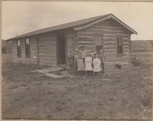 hisotric Photo of old small school house and kids