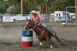 Girl Barrell racing at the Rodeo
